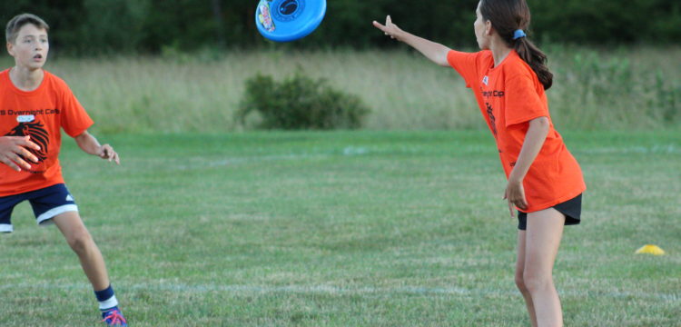 Two children throw a frisbee back and forth